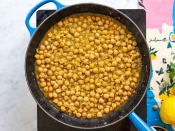 Step 3 Chickpeas simmering in lemon broth with creamy sauce forming in pan.