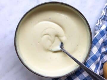 Step 3 Creamy yogurt dressing being whisked in a small bowl.