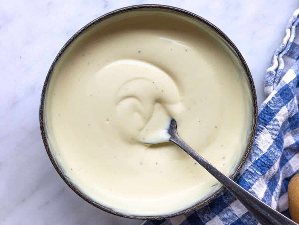 Step 3 Creamy yogurt dressing being whisked in a small bowl.