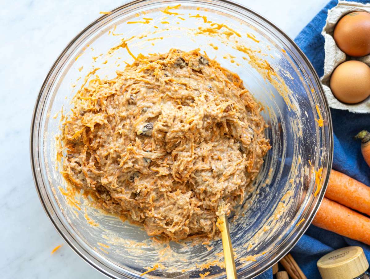 Step 3 Folding grated carrots walnuts and raisins into thick batter.