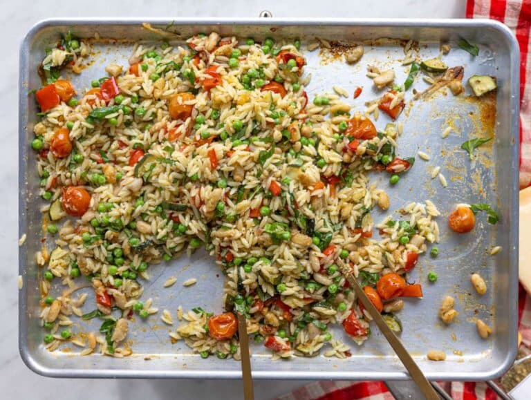 Step 3 Hot orzo added to roasted vegetables on sheet pan with parmesan sprinkled.