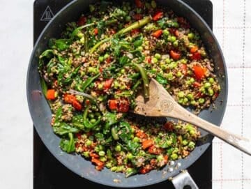 Step 3 Spinach wilting into quinoa mixture in pan with herbs and seasoning.