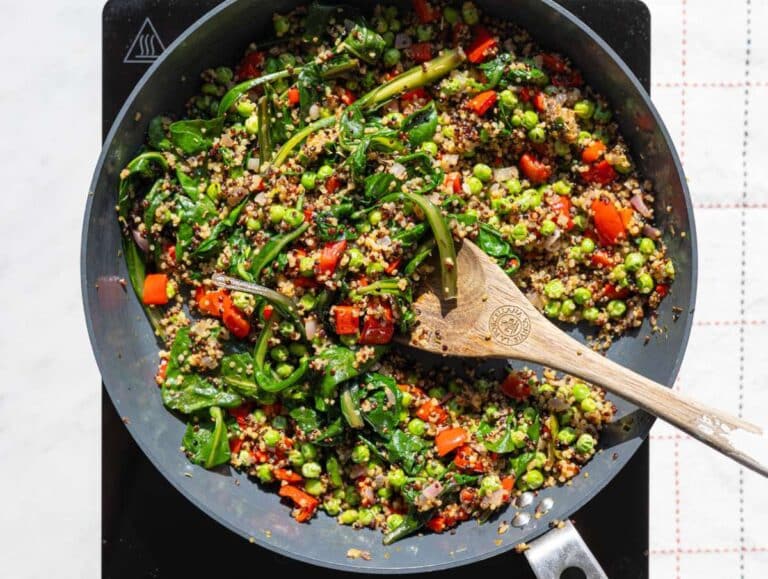 Step 3 Spinach wilting into quinoa mixture in pan with herbs and seasoning.