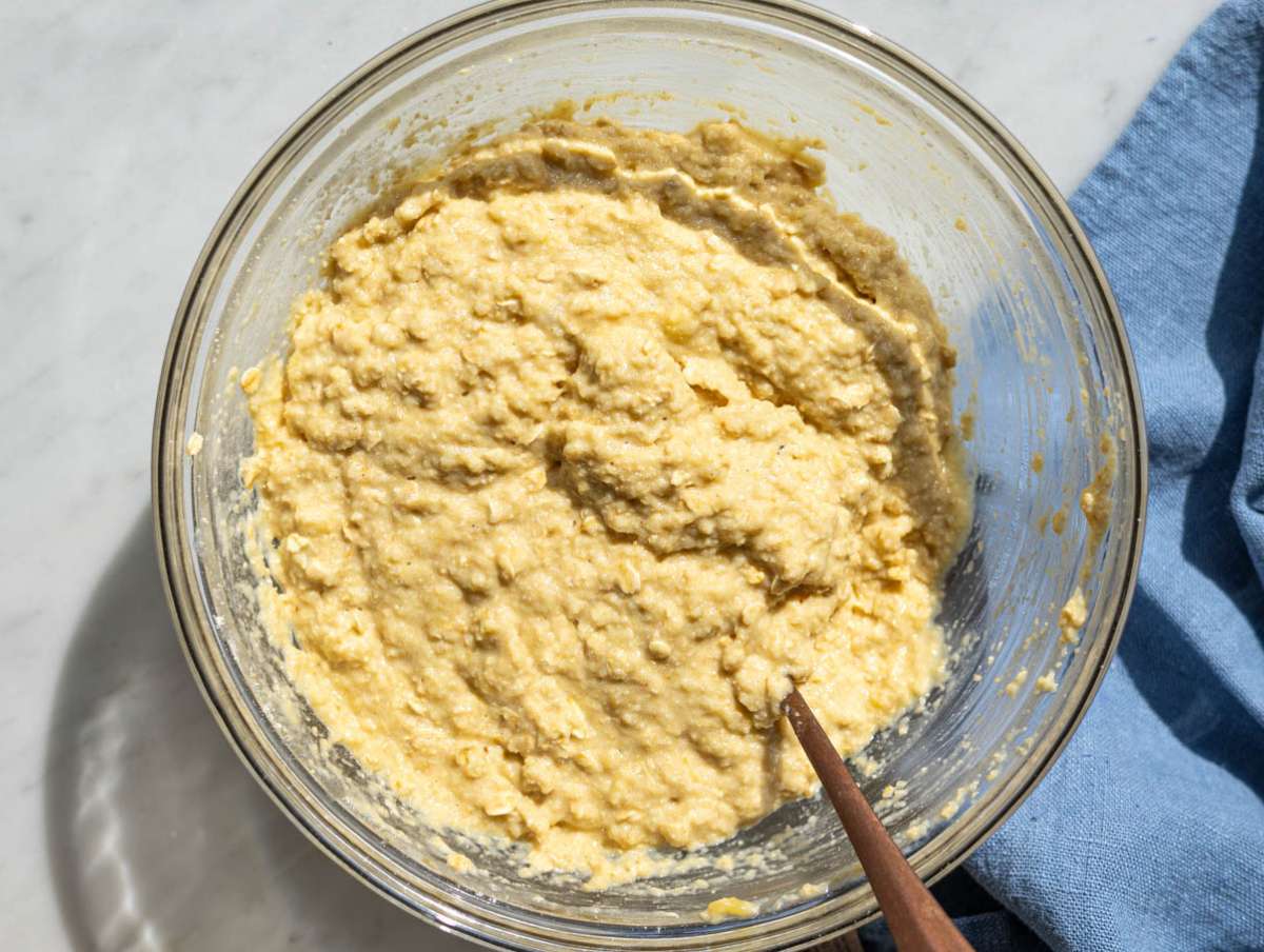 Step 3 Stirring almond flour and oat flour into a thick muffin batter with a spoon.