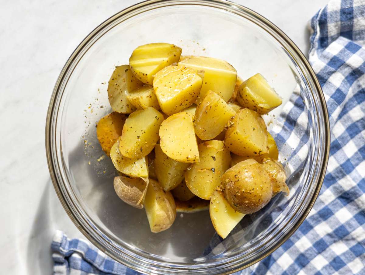 Step 3 Warm potato chunks tossed with olive oil dressing in a large bowl.