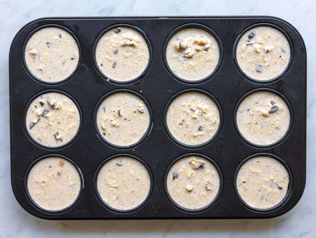 Step 4 Batter spooned into greased muffin pan cups.
