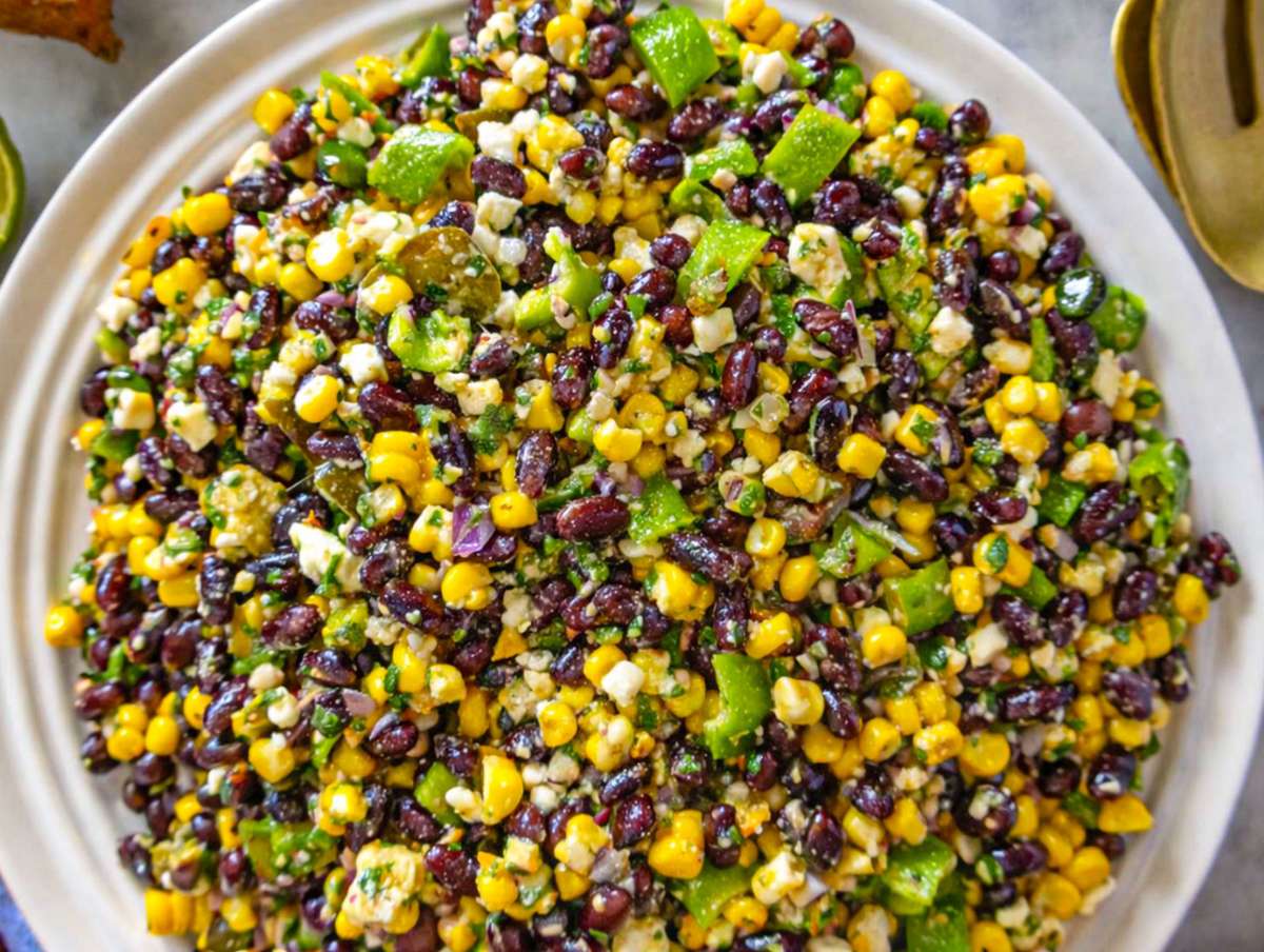 Step 4 Bowl of chopped black bean salad served on marble table in natural light.