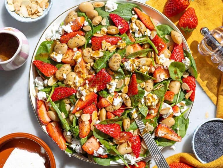 Step 4 Drizzling dressing over strawberry spinach salad with almonds and feta on top.