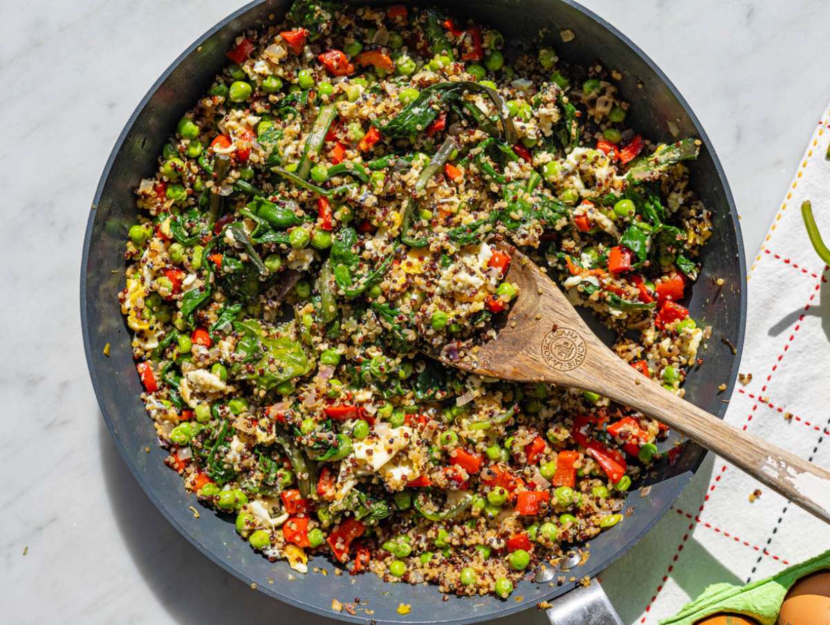 Step 4 Eggs cooking in center of skillet surrounded by quinoa and vegetables.