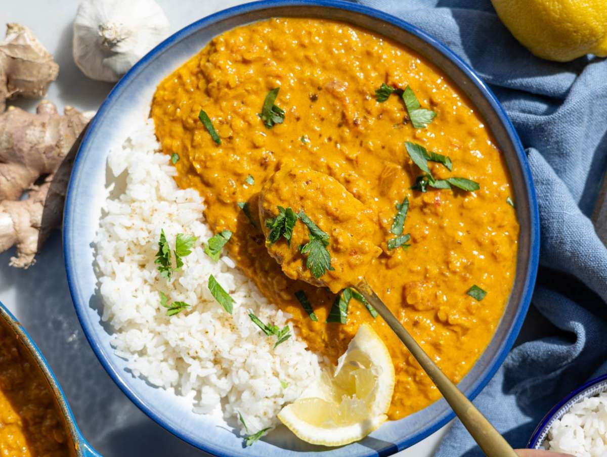Step 4 Garnishing the creamy lentils with fresh herbs and a squeeze of lemon.