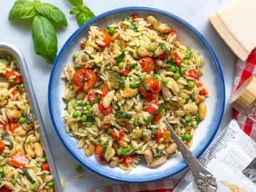 Step 4 Orzo primavera served in a bowl on marble kitchen counter.
