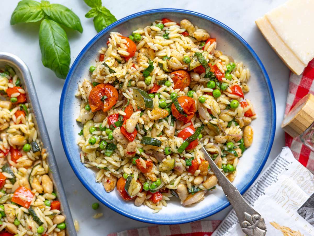 Step 4 Orzo primavera served in a bowl on marble kitchen counter.