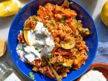Step 5 Bowl filled with roasted vegetable rice and yogurt drizzle on top.
