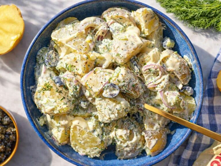 Step 5 Potato salad being gently mixed until creamy and well coated.