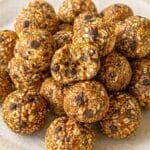 Banana bread energy balls stacked on a plate, bright natural light, clean marble background.