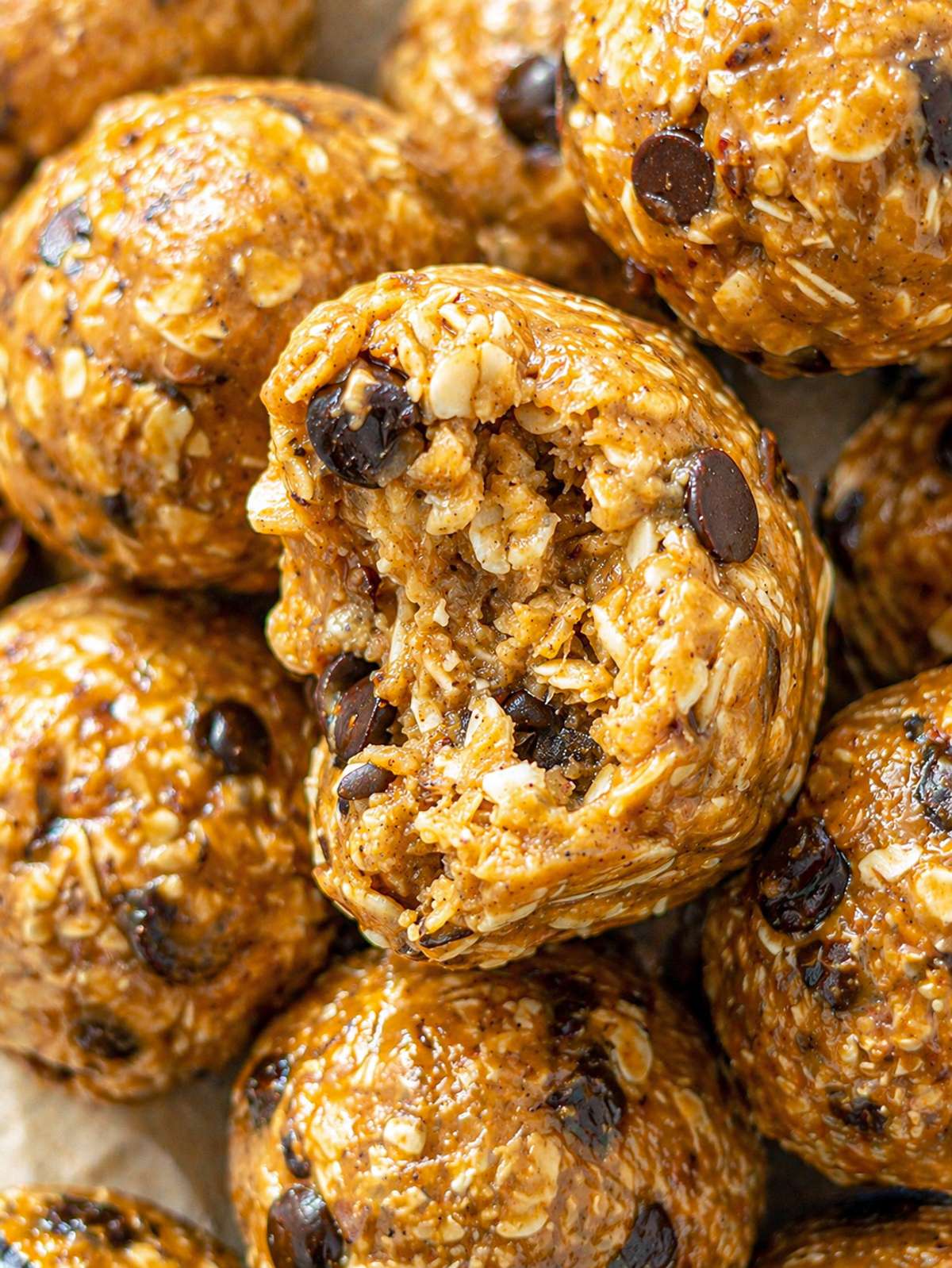 Close-up of chewy peanut butter energy balls with chocolate chips and oats.