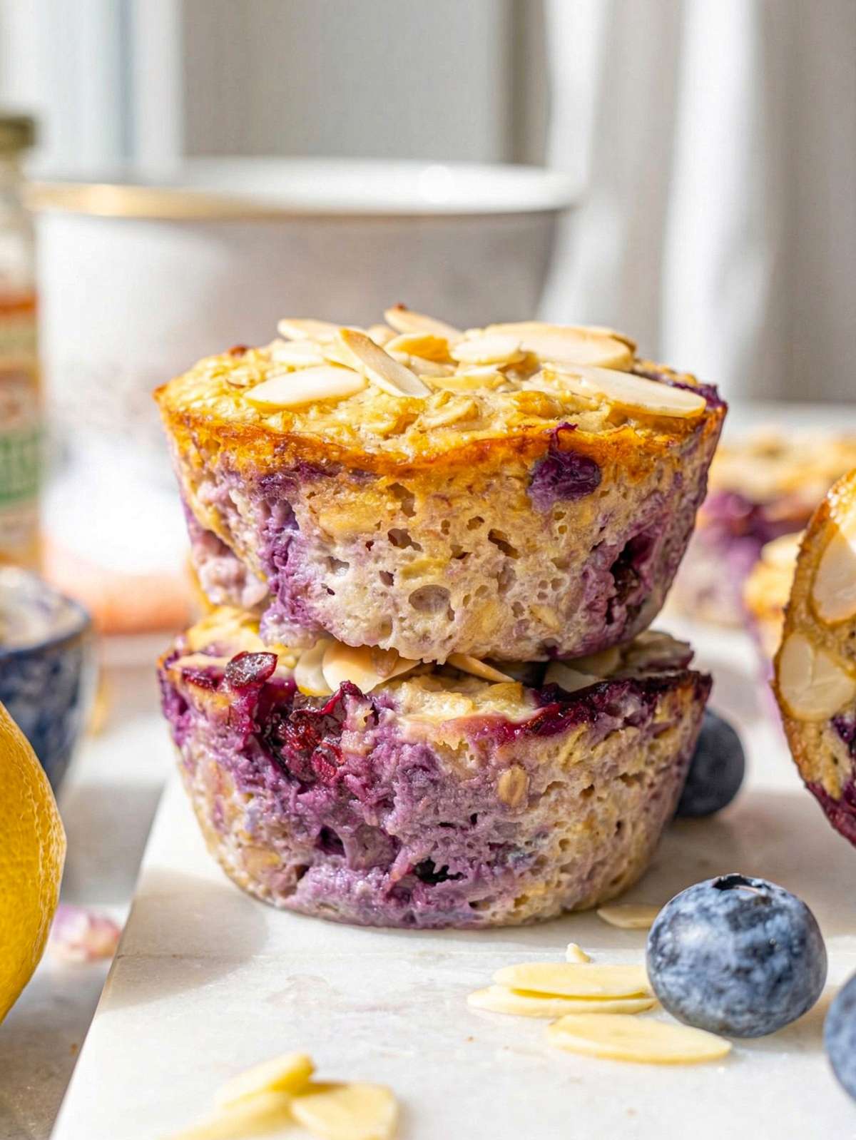 Close up of moist blueberry baked oatmeal cup showing soft texture and juicy blueberries.
