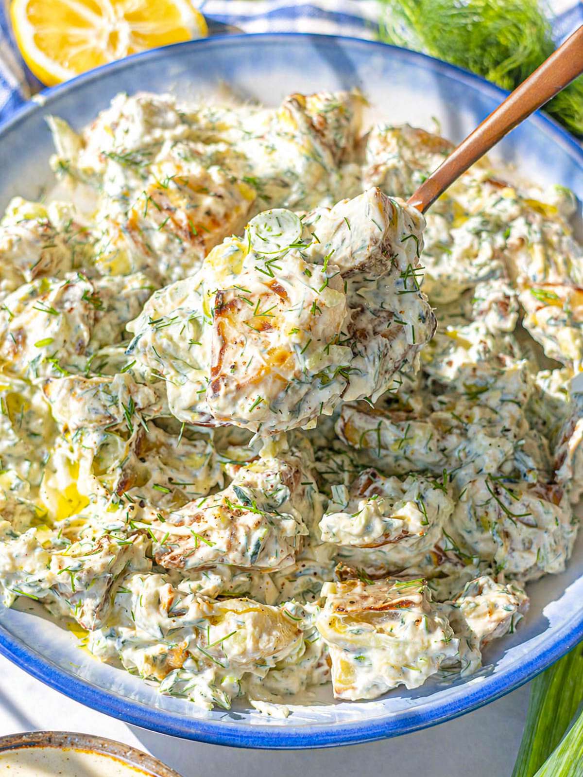 Close up of roasted potato salad showing creamy texture and tender potatoes.