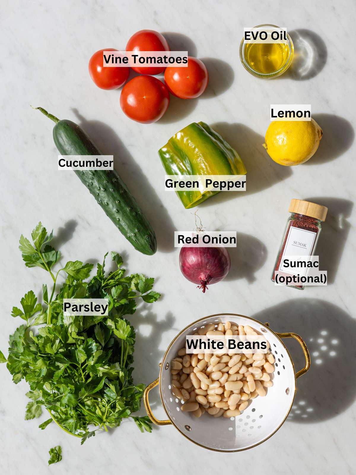 Fresh ingredients for Turkish shepherdâs salad on marble table in natural light.