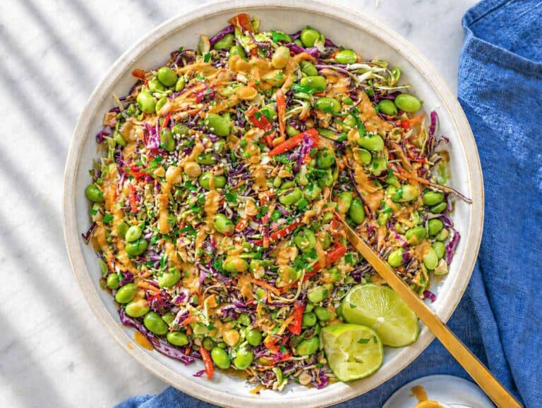 Fresh vegetables tossed together in a large bowl, showing color and texture contrast.