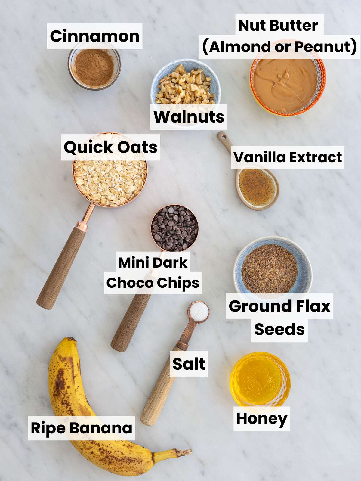 Ingredients arranged in small bowls on marble surface with natural window light.