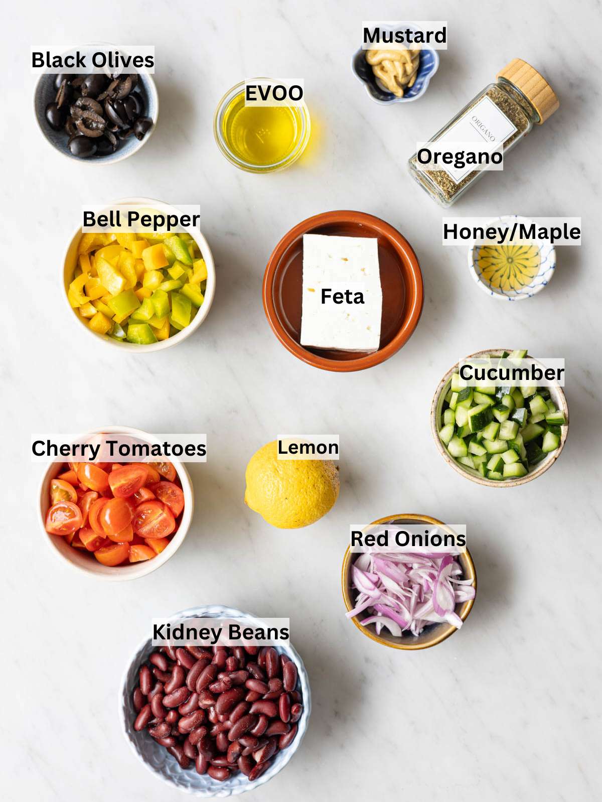 Ingredients for kidney bean salad arranged on marble surface with natural window light.