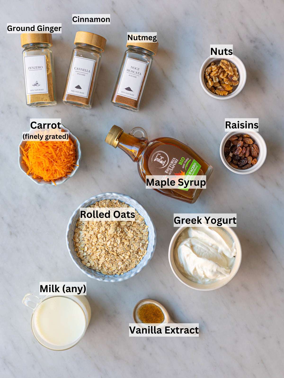 Ingredients neatly arranged on marble surface in natural light, oats, yogurt, carrots, spices.