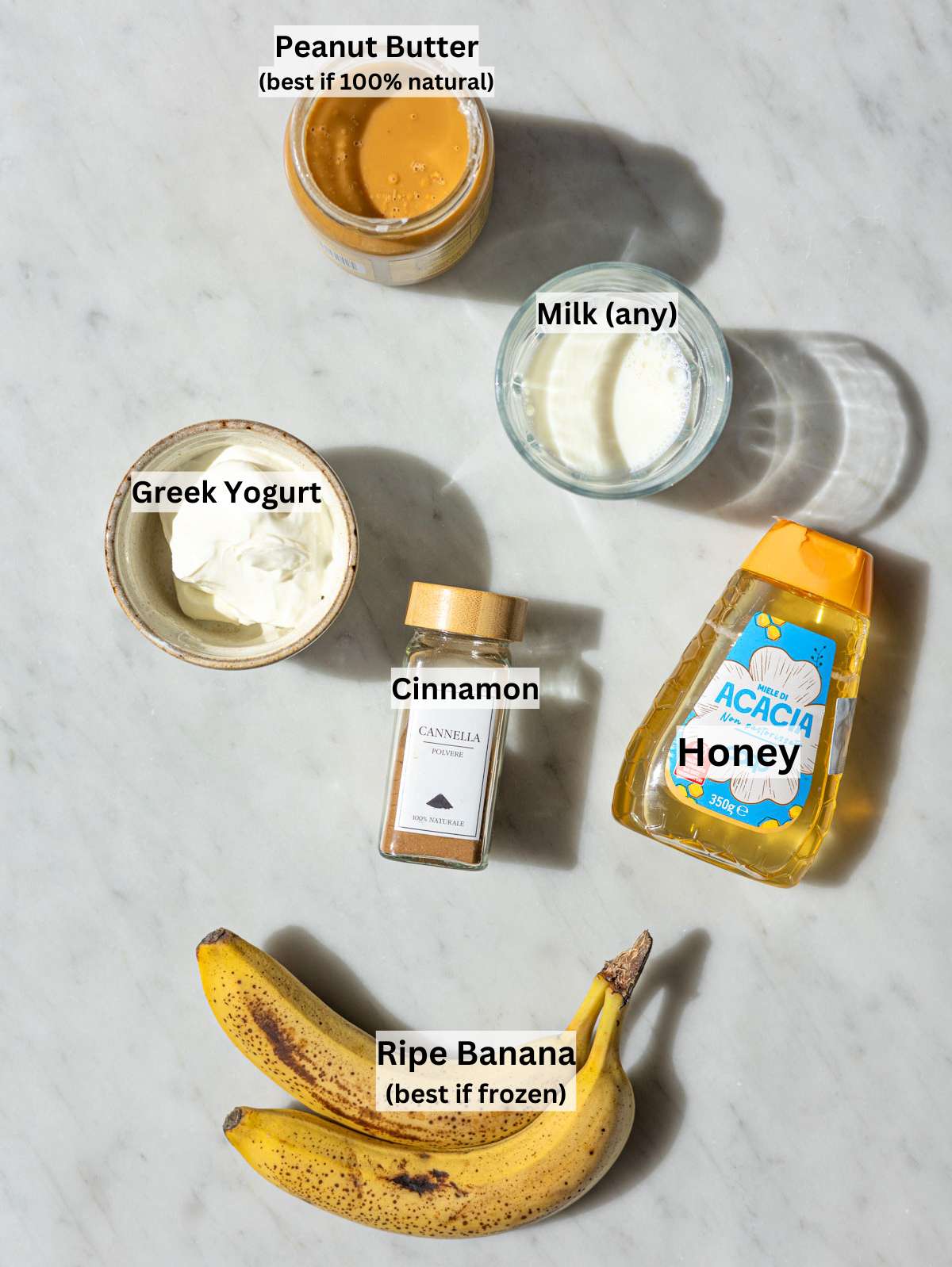 Ingredients neatly arranged on marble surface in soft natural window light.