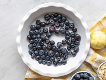 Step 1 Blueberries spread in a greased baking dish before adding the batter.