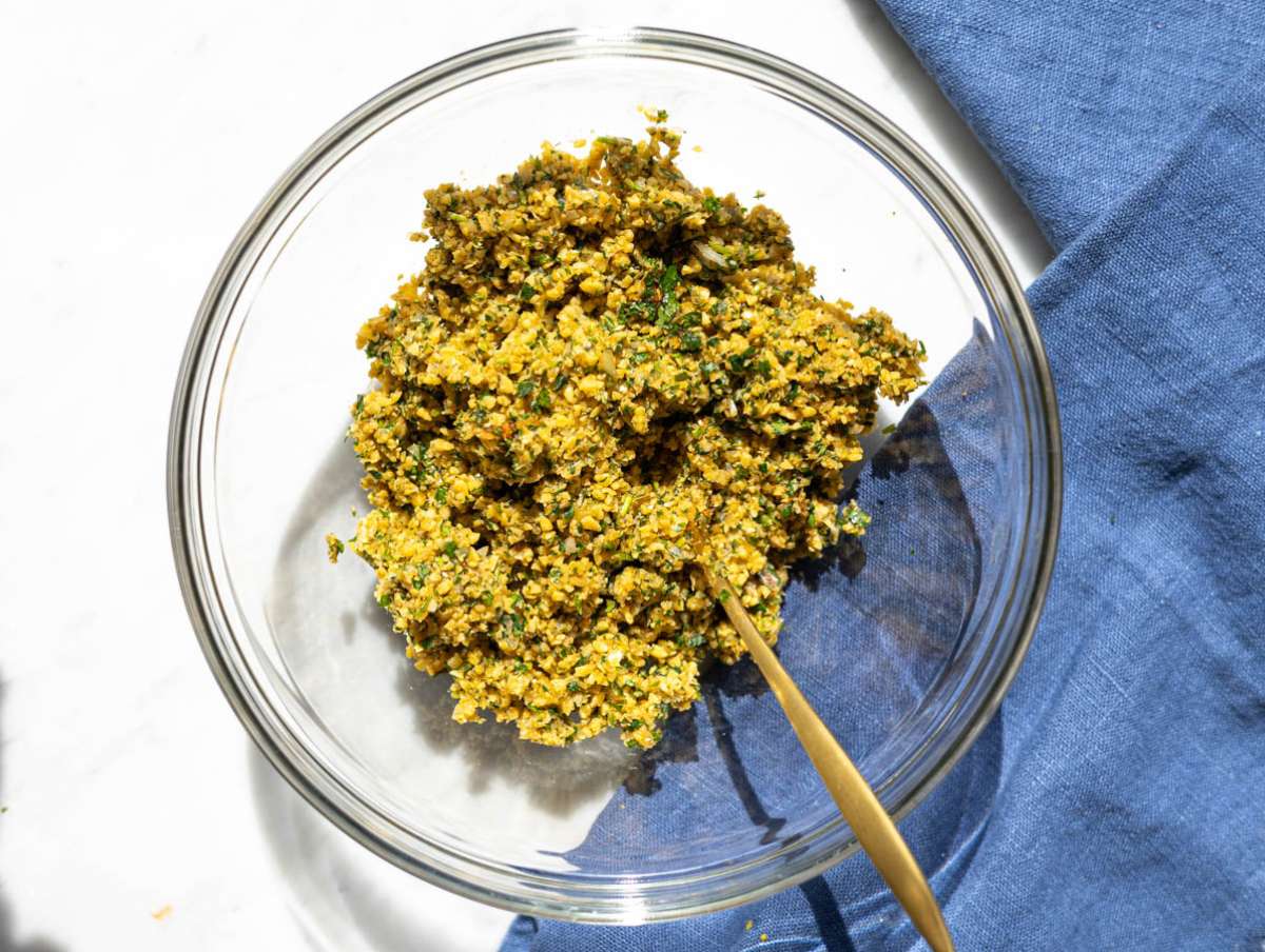 Step 1 Chickpeas, herbs, onion, and garlic pulsed into coarse falafel mixture.