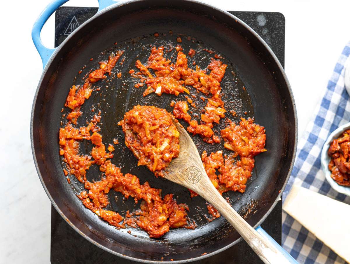 Step 1 Chopped onion cooking in olive oil in skillet with soft light from nearby window.