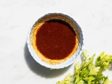 Step 1 Mixing shawarma spices with olive oil and garlic in small bowl on marble surface.