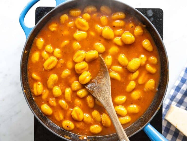 Step 2 Gnocchi simmering in tomato broth sauce in skillet as sauce thickens.