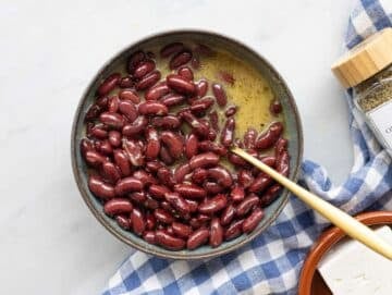 Step 2 Kidney beans coated in dressing in bowl ready to marinate.