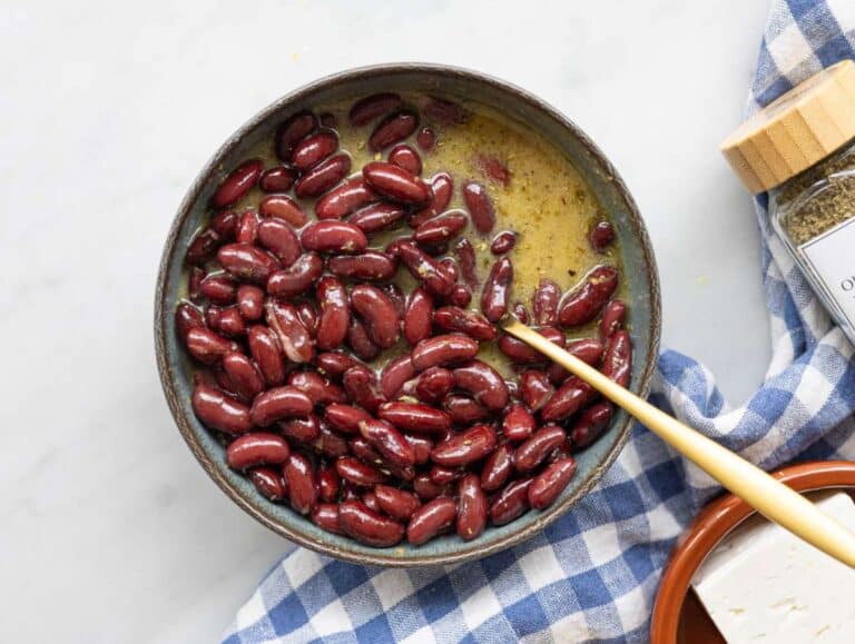 Step 2 Kidney beans coated in dressing in bowl ready to marinate.