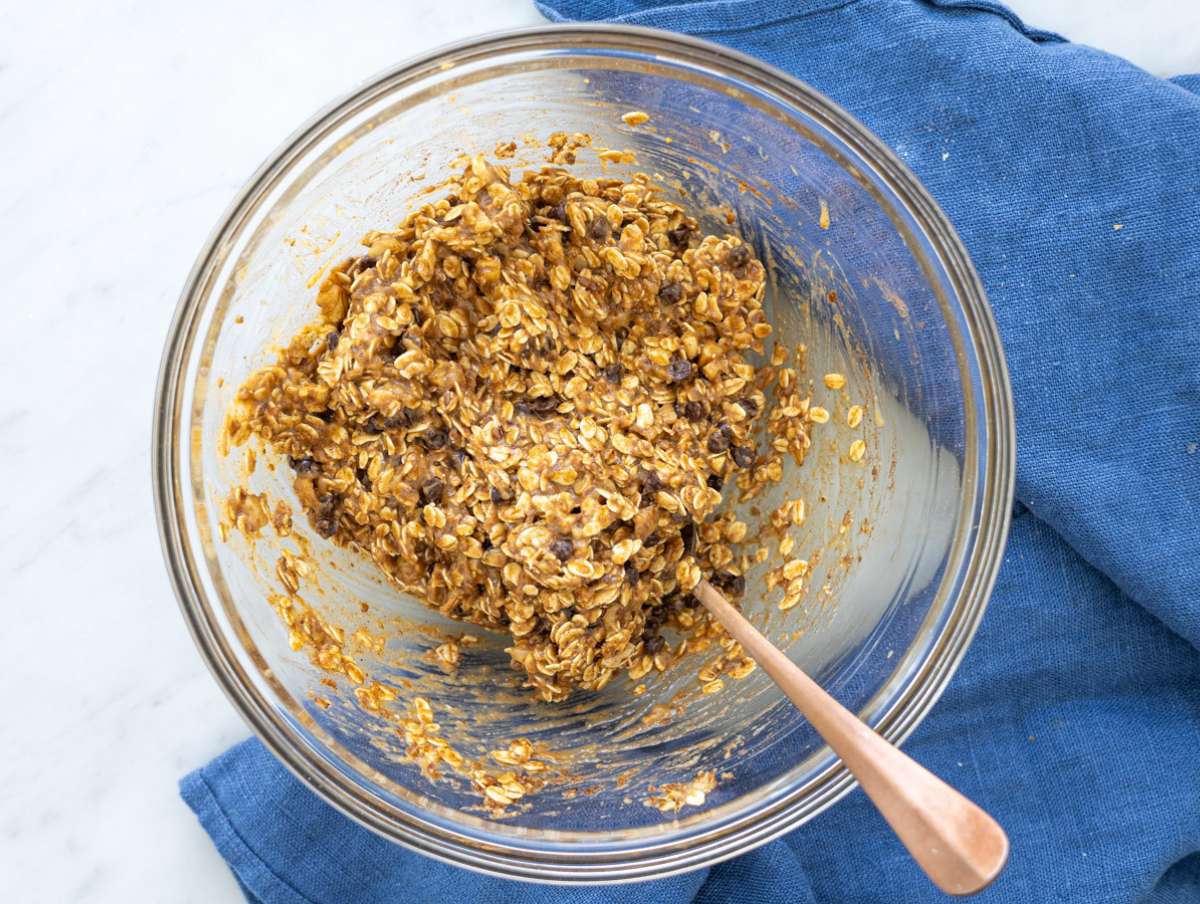Step 2 Oats, nuts, and chocolate chips mixed into soft dough in bowl.