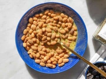 Step 2 Pinto beans mixing with dressing in bowl, glossy and well coated.