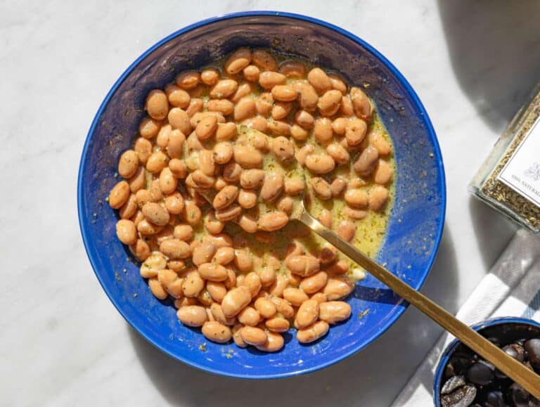 Step 2 Pinto beans mixing with dressing in bowl, glossy and well coated.