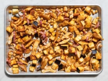 Step 2 Tossing chickpeas, eggplant, and mushrooms with spices on sheet pan.