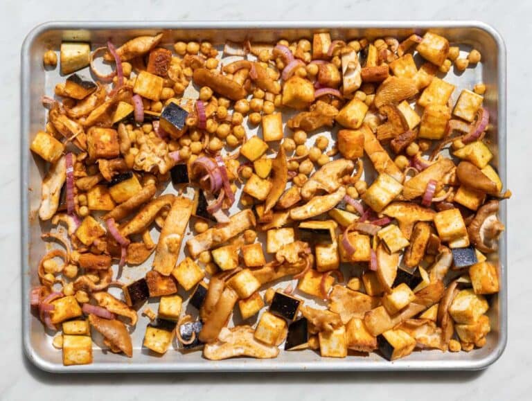 Step 2 Tossing chickpeas, eggplant, and mushrooms with spices on sheet pan.