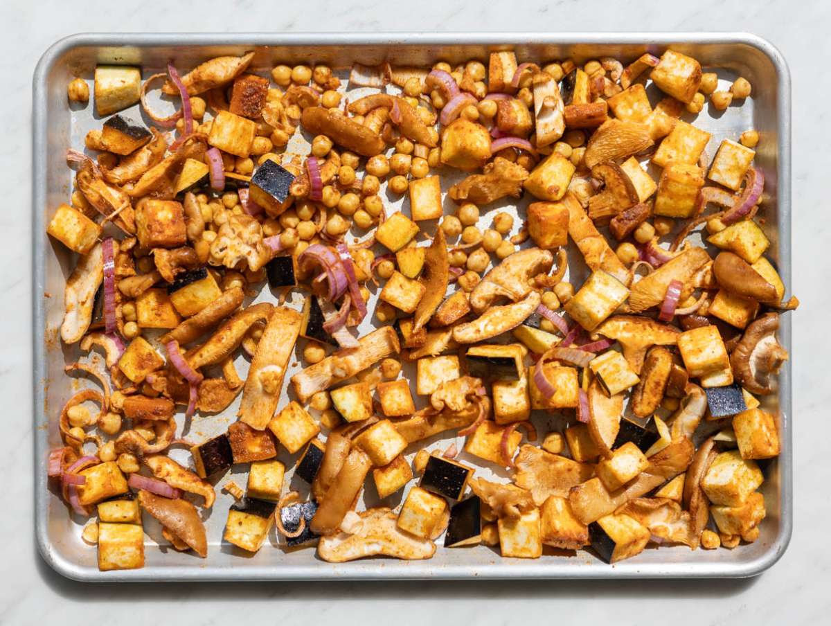 Step 2 Tossing chickpeas, eggplant, and mushrooms with spices on sheet pan.