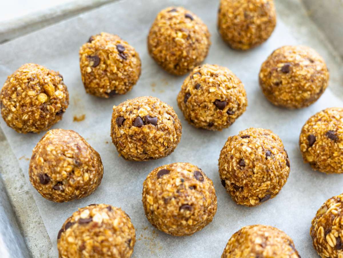 Step 3 Energy balls resting on a plate before chilling, soft natural light.
