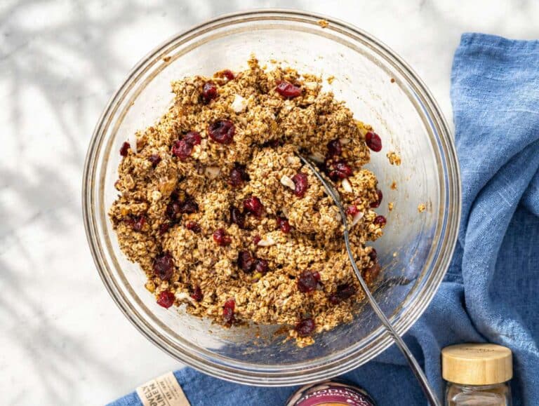 Step 3 Oat mixture with dried fruit and seeds in a glass bowl ready to press.