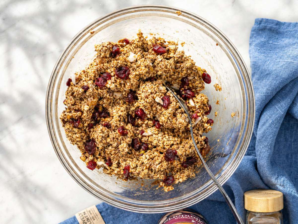 Step 3 Oat mixture with dried fruit and seeds in a glass bowl ready to press.