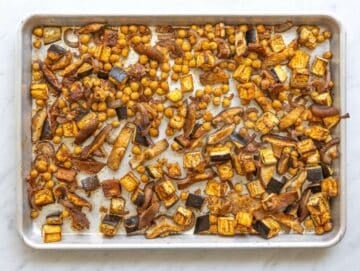 Step 3 Roasted vegetables and chickpeas on tray with golden edges after baking.