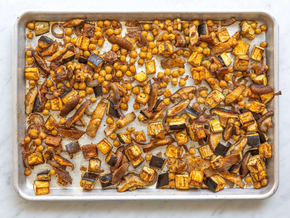 Step 3 Roasted vegetables and chickpeas on tray with golden edges after baking.