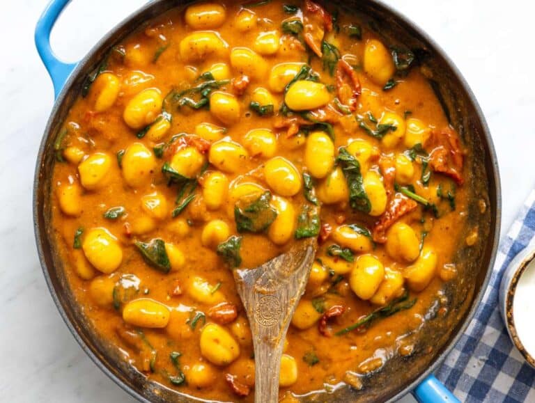 Step 3 Spinach and sun-dried tomatoes added to gnocchi in skillet turning vibrant green.
