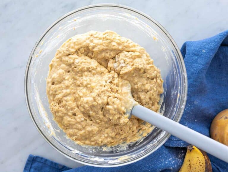 Step 3 Thick muffin batter with oats and flour being gently folded with spatula.