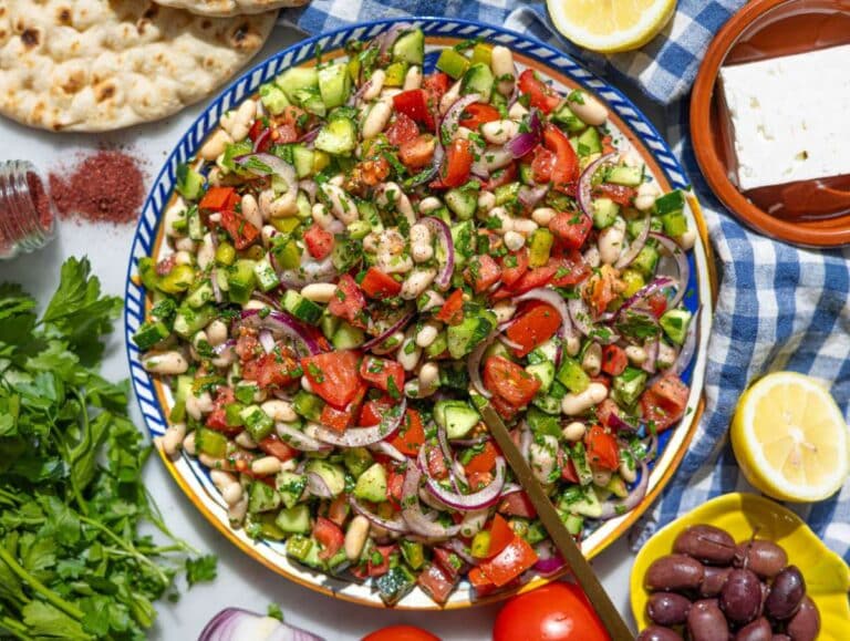 Step 3 Turkish shepherdâs salad served with pita feta and olives on marble table.