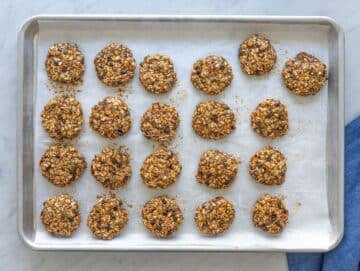 Step 3 sticky cookie dough shaped into thick rounds on a baking sheet.